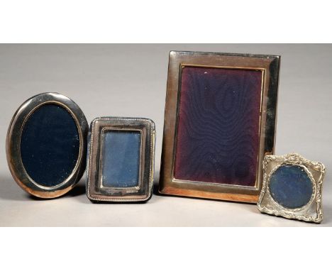 AN EDWARD VII MINIATURE SILVER PHOTOGRAPH FRAME, 6.5CM H, MARKS INDISTINCT, BIRMINGHAM 1905 AND THREE ELIZABETH II SILVER PHO