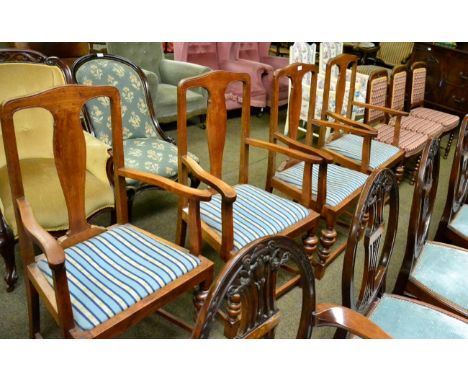 A set of four oak open armchairs with drop in seats together with three upholstered side chairs on bobbin turned supports 