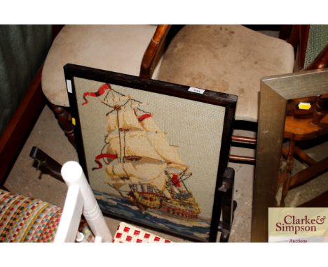 An embroidered fire screen decorated with a galleon