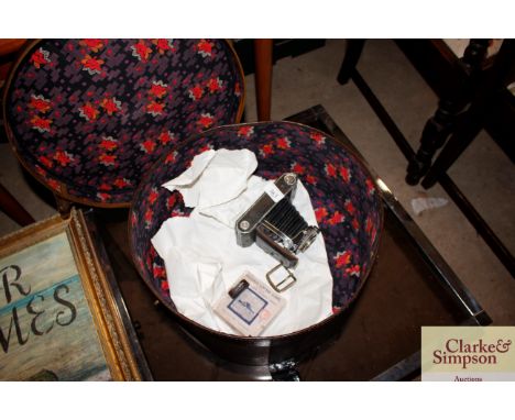 A Kodak Vollenda camera and a box of coloured magic lantern slides; British battle ships contained in a vintage hat box