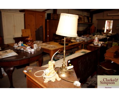 A cherub decorated table lamp and a brass table lamp