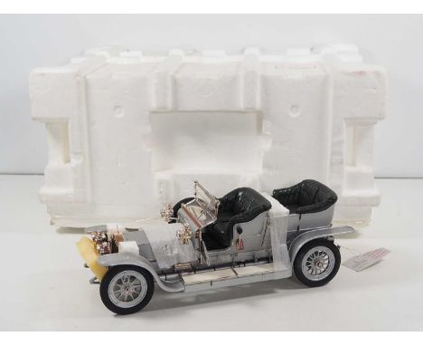 A FRANKLIN MINT 1:12 scale diecast 1907 Rolls Royce Silver Ghost - appears undisplayed in original shipping outer - VG in G/V