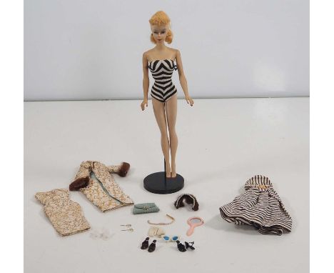 An original vintage MATTEL BARBIE doll, circa 1959/60, complete with swimsuit, mule shoes, sunglasses and a number of further