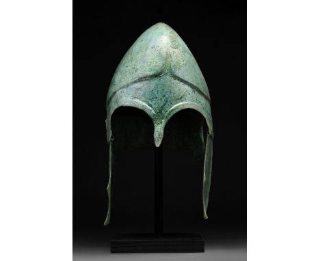 Circa 400 BC An attractive Greek Chalcidian Hoplite Helmet with cheek-guards, mounted on a custom made stand. The Chalcidian 