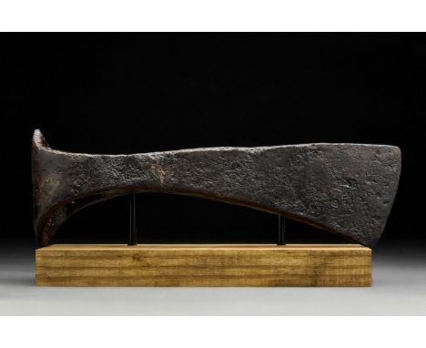 Circa 900-1000 ADAn iron axe head comprising a short, curved blade, elongated cheek, lozenge-shaped poll and round socket. Fa
