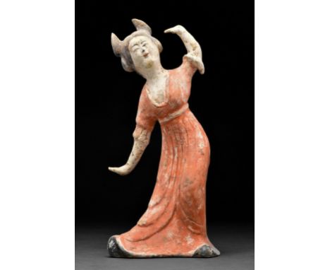 Circa 618-907 ADA delicate Tang Dynasty dancer wearing a long flowing gown with her hands uncovered. The dress is a deep oran