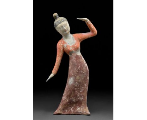 Circa 618-907 ADA delicate Tang Dynasty dancer wearing a long flowing gowns with her hands uncovered. The dress is a deep red