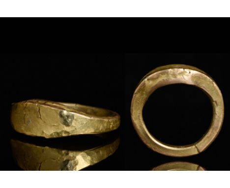 Circa 900-1000 ADA gold ring with oval shaped bezel, a thick band which tapers from the shoulder around the hoop. A finelly m