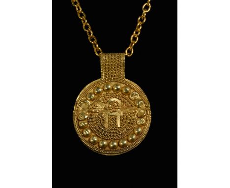 Circa 500 BCA finely rendered Phoenician gold disc-shaped pendant, hammered from thin gold, three channels of decoration run 