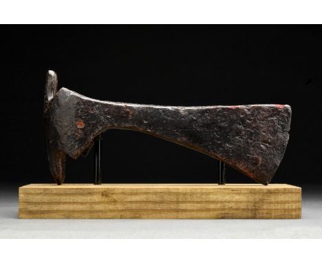 Circa 900-1000 ADA forged-iron axe head of a hefty form with a perforated socketing shaft, a dense neck and a vertically orie