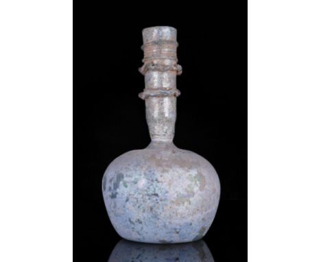 Circa 200-300 ADAn elaborately modelled glass flask in light green with long everted neck and bulbous shaped body, the neck h