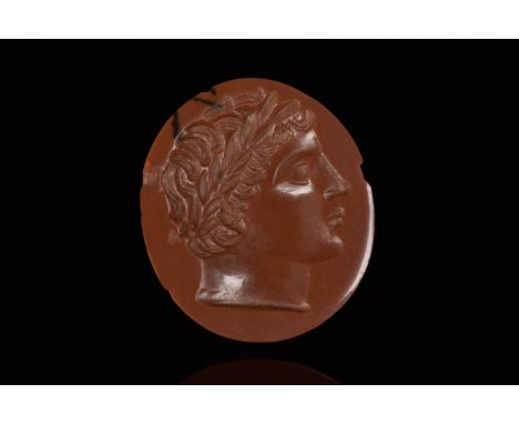 Circa 1800 AD or earlierAn oval shaped intaglio with a bust of youthful male, possibly of Apollo facing right, full lips and 