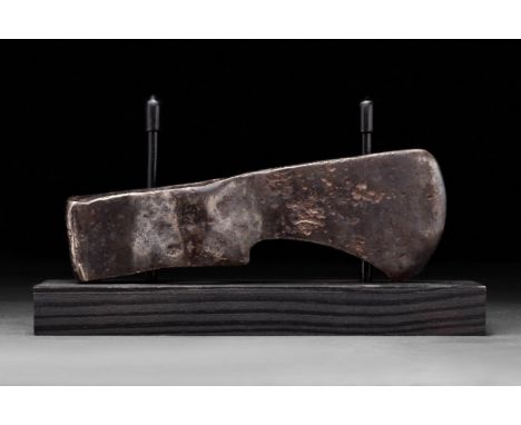 Circa 900-1000 ADA forged-iron axe head of a hefty form with a perforated socketing shaft, a dense neck, and a vertically ori