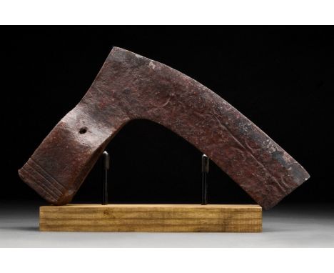 Circa 900-1000 ADAn iron bearded axe head with an elongated, heavy blade and a round socket. One side of the blade features a