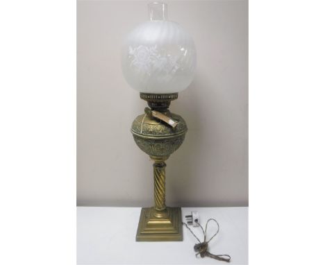A Victorian brass twist column oil lamp with glass chimney and shade (converted)