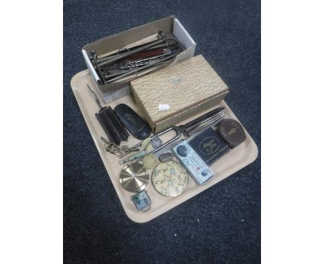 A tray of assorted collectable's including hair curlers, folding coat hangers, vintage spectacles, compacts, boxed cocktail o