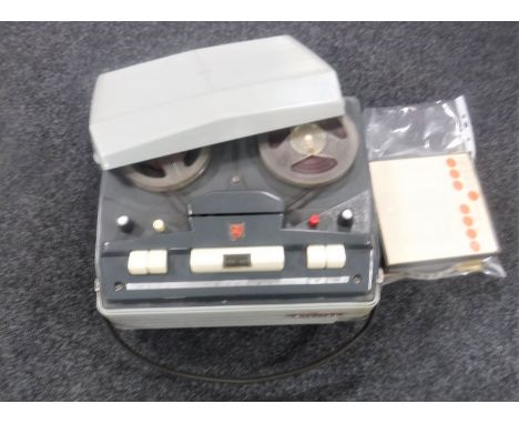 A vintage reel to reel player with reels 