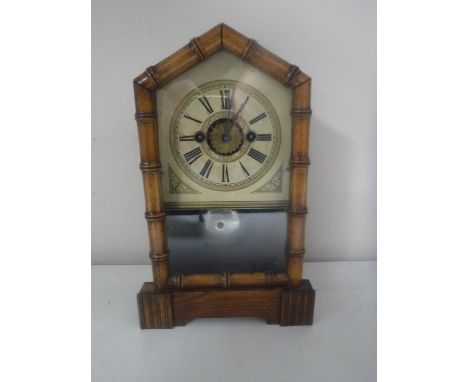 A pine cased American eight day mantel clock 