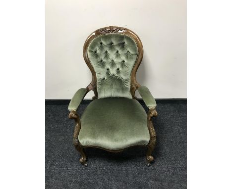 A Victorian armchair in green button dralon 