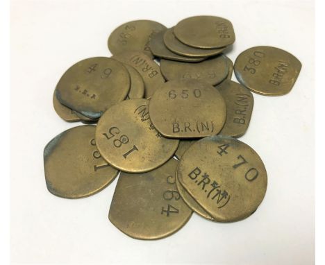 Twenty vintage brass railway pay check tokens. (20)