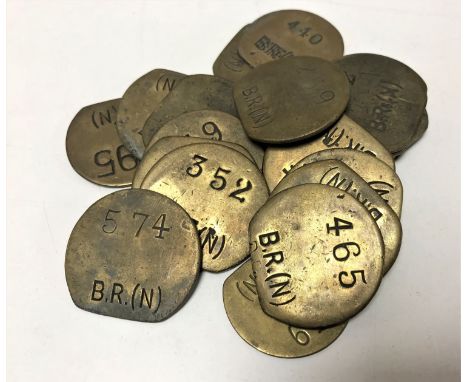 Twenty vintage brass railway pay check tokens. (20)