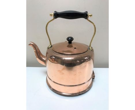 A vintage copper and brass electric kettle