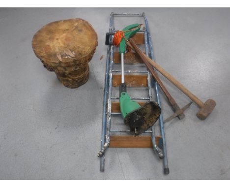 A set of folding metal steps, electric strimmer, pick axe, sledge hammer and a tree stump stool 