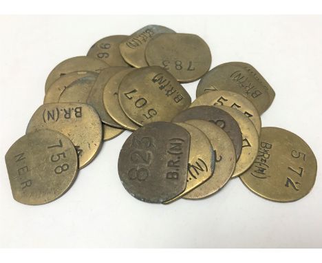 Twenty vintage brass railway pay check tokens. (20)