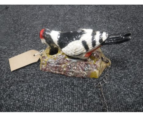 A cast metal woodpecker door knocker 