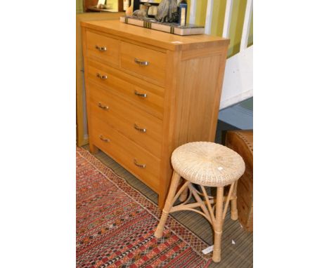 A light wood chest of two small over three long drawers 87 x 97 x 41 cm with a wicker top stool