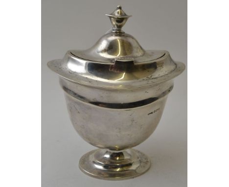 Asprey and Co Ltd, a Regency design silver tea caddy, hinged cover raised on an oval base, Sheffield 1912, 18cm high, 390g