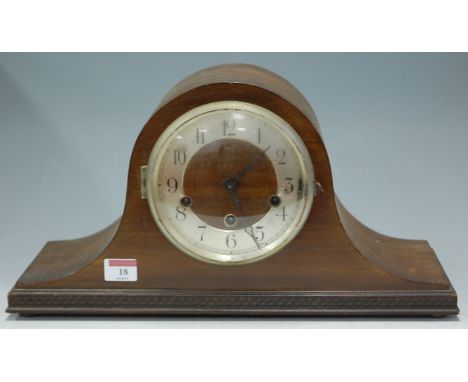 A 1930s oak cased mantel clock having a silvered dial with Arabic numerals and eight day movement striking on a gong