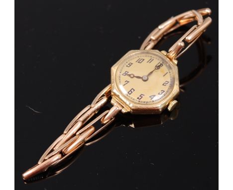 A ladies vintage 18ct gold mechanical wrist watch, the champagne dial within hexagonal case, manual wind movement, and on 14c