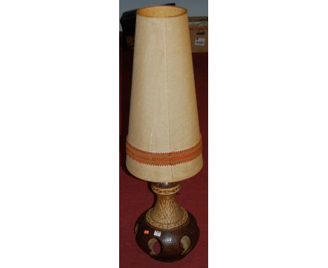 A large 1970s West German pottery table lamp having conical shade and pierced bulbous brown glazed body