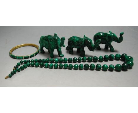 A set of three carved malachite figures of elephants; together with a malachite graduated beaded necklace; and a malachite ba