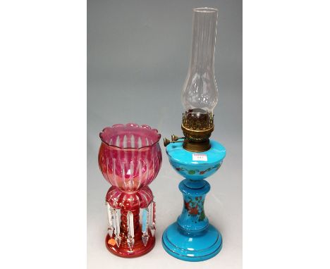 An early 20th century Bohemian style ruby glass lustre with glass prism drops; together with a blue glass pedestal oil lamp (