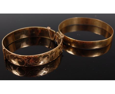 An 8ct gold plain bangle, 16g, together with a rolled gold hinge bangle (2)