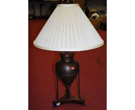 A large modern table lamp of squat baluster form having Egyptian style mounts on platform base with pleated silk shade