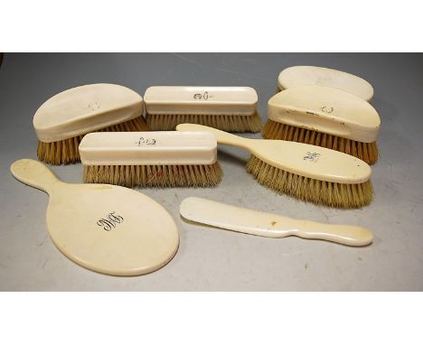 A Victorian ivory backed dressing table set comprising clothes brushes, hair brush, mirror, shoehorn etc each with engraved a