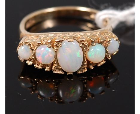 A 9ct gold and cabochon opal set five stone ring, 3.7g, size M