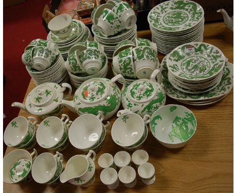 An extensive part tea and dinner service, on a white ground decorated with green dragons, by various factories to include; Co