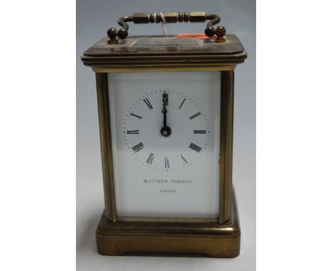 An early 20th century lacquered brass cased carriage clock, having an enamelled dial with Roman numerals, signed Matthew Norm