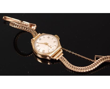 A vintage ladies 9ct gold mechanical wrist watch having an unsigned champagne dial, subsidiary seconds dial, and on a 9ct gol
