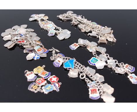 A large quantity of silver travel charms, all being enamel set and mounted on numerous chains, 193g