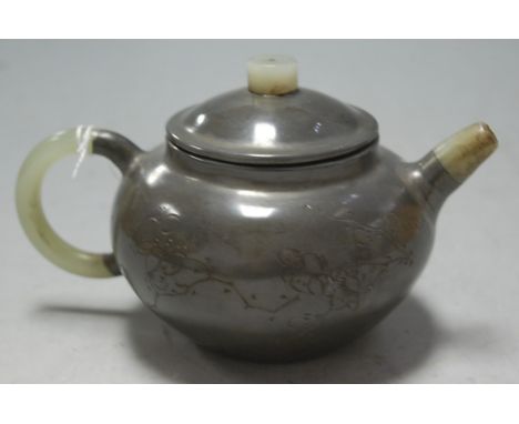 A Chinese pewter teapot of squat circular form engraved with peony having jadeite spout, finial and handle, height 9cm   Cond