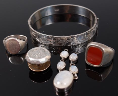 Silver costume jewellery to include; hinged bangle, signet rings, dress button, and moonstone set pendant (5)