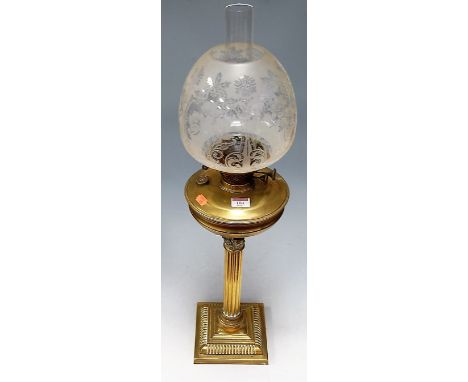 A Victorian brass oil lamp, having etched globular shade and brass reservoir, on Corinthian column and stepped base, h.77cm  