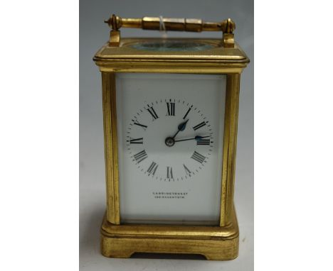 An early 20th century lacquered brass cased carriage clock having white enamel dial, Roman numerals, and signed Carrington & 