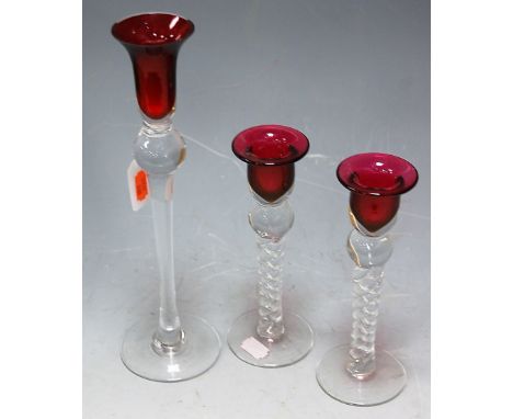 A pair of modern Bristol glass table candlesticks, each having ruby coloured bowl on spiral twist stems and conical footrims;