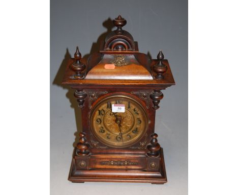 A late 19th century continental walnut cased mantel clock, having pressed brass dial with Arabic numerals, h.45cm 